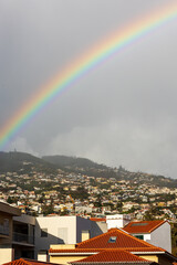 rainbow over the roofs of houses in the sky