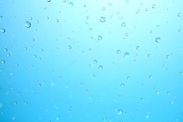 Clear water droplets floating against a light blue background