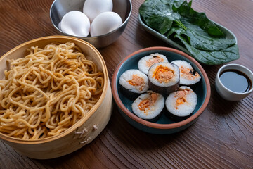 Close-up of dim sum setup sushi,noodles and egg