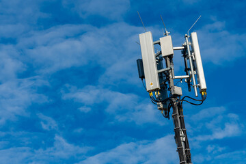Cell tower stands tall against a clear blue sky