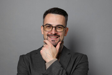 Portrait of handsome middle aged man on grey background