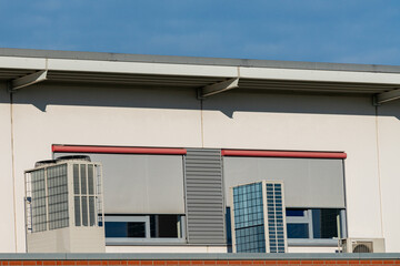 Modern building facade with window shades and ventilation units