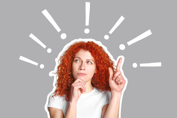 Obraz premium Thoughtful redhead woman with raised index finger on grey background