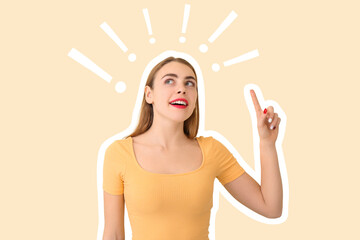 Beautiful young woman with raised index finger on color background