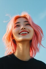 Fototapeta premium Happy young woman with pink hair smiling into the camera outdoors