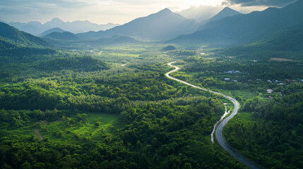 aerial top view beautyfull curve road on green forest in the rain season background, rural routes connecting cities in the north of thailand 