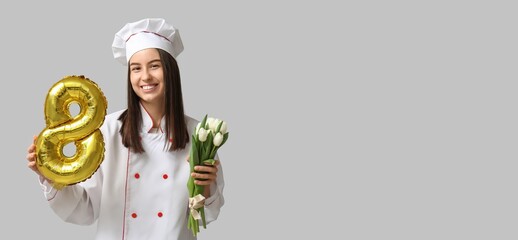 Female chef holding tulips and balloon in shape of figure 8 on grey background with space for text. International Women's Day celebration