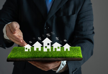 Businessman offers mortgage loans for the purchase of houses. Real estate developer. Home buying....