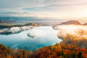 Aerial view of the alpine Lake Bled covered in morning mist from the Osojnica viewpoint. Location...