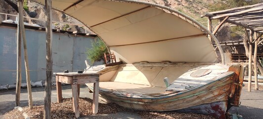table and bed in the form of a boat on one of the beaches based on Santorini Greece