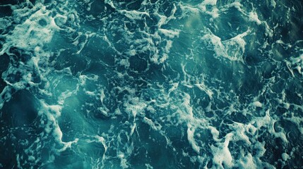 Fototapeta premium A close-up of swirling ocean waves with a dramatic, dark blue tone.