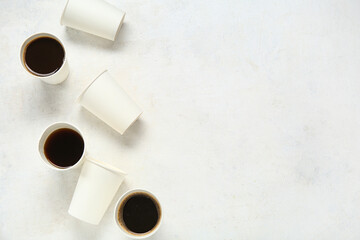 Paper cups of hot coffee on white background