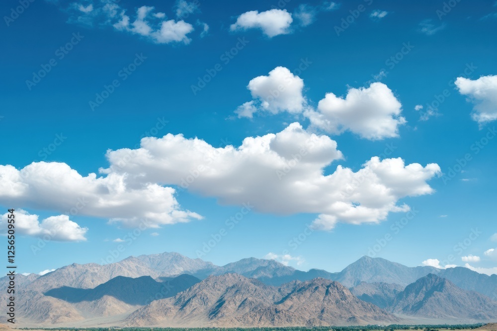 Poster Majestic mountain range under soft clouds and blue sky with space for text. Generative AI