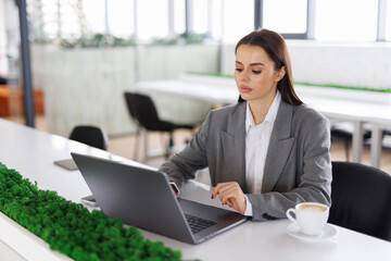 Stylish woman manager freelancer working on laptop