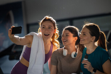 Small group of women taking selfie in gym
