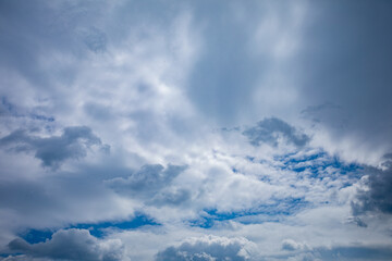 A stunning and dynamic sky is beautifully adorned with clouds and accentuated by blue touches