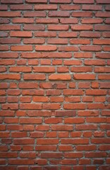 Fototapeta premium Old red brick wall background with even masonry. Ancient building exterior with rough texture. Retro backdrop presents building industry, construction. Calm vintage design, abstract pattern in urban