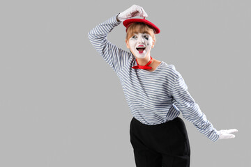 Female pantomimist  on grey background