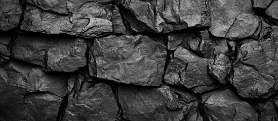 A Close-Up View of a Textured, Dark Gray Stone Wall, Displaying Intricate Patterns and Details.