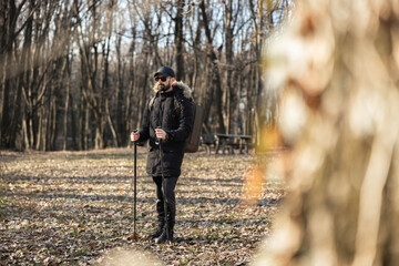A man pauses in the woods, capturing a moment of contemplation and connection with nature while...