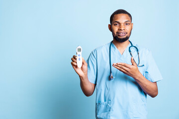 African american nurse advertising thermometer tool to measure fever levels, using accessory...