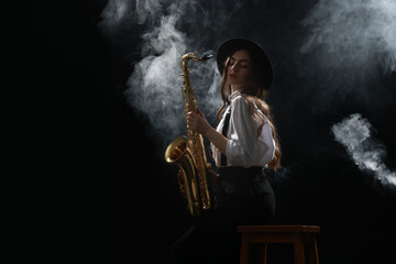 Professional musician playing saxophone on dark background with smoke