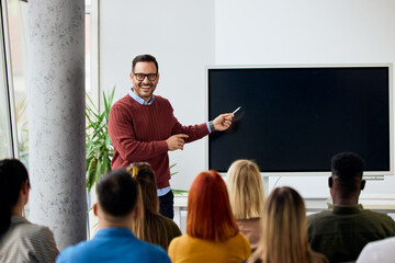 Professional Instructor Giving Presentation to Attentive Audience in a Modern Classroom Setting