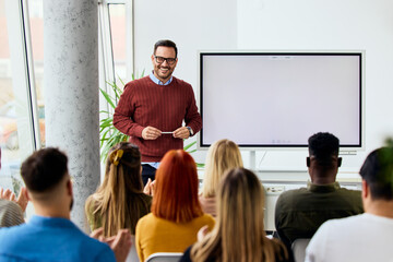 Smiling Presenter Leading Team Meeting in Bright Modern Office Environment
