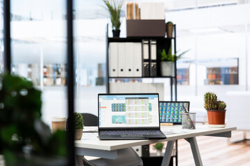 Empty company financial department with stock portfolio on laptops containing collection of investment assets. Workspace with live index indices on notebook screen showing stock demand surge