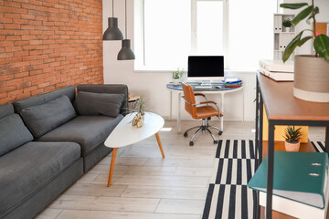 Interior of modern office with workplace and sofa