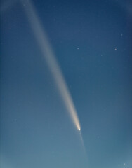 Comet 2023 A3 Tsuchinshan ATLAS Interstellar comet. A comet with a long tail crossing space. Comet stars and night sky blue sky with stars © Hector
