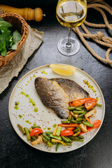 Grilled sea bream fillet with vegetables and lemon, plated with elegant garnish, fine dining style