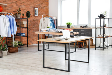 Interior of men's clothing store with shelf units and tables