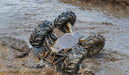 ATV overturned in the mud. ATV accident.