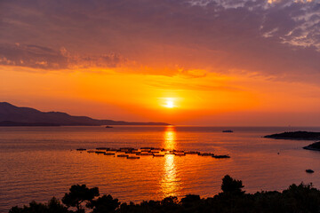 Fototapeta premium sunset at the beachAlbania, Vlorë County, Ksamil - 18 August 2024 - The sky of Ksamil at sunset is illuminated by the heat of the Sun
