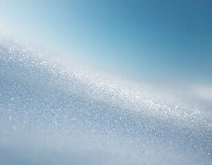 A glistening snow surface under a clear blue sky creates a serene winter landscape.