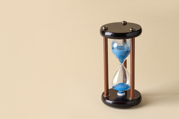 Hourglass on beige background. Time management concept