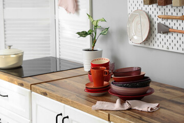 Bowls and plates on table near white wall in kitchen