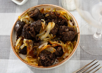 Delicious fried morcilla (blood sausage with rice) and grilled onion served on plate. Spanish dish