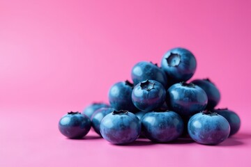 Stack of blueberries, vibrant pink background, ripe, freshness, fruit