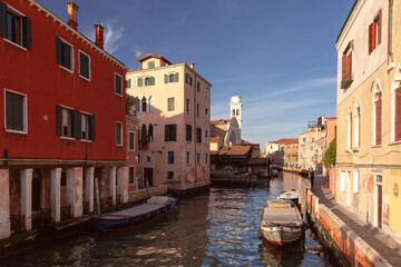 Scenic view of traditional old Venetian houses over a canal and boats, Venice, Italy