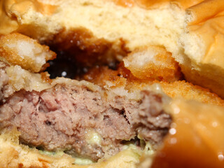 details of burger with breaded onions. meat with bread and onion. food with selective focus. food background.