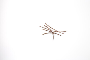 small brown twigs lying on a plain white background. natural material for crafting and DIY project, top view white background,