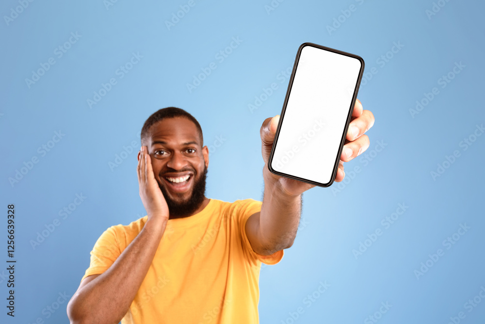 Poster check out this cool mobile app. excited african american man presenting smartphone with empty screen