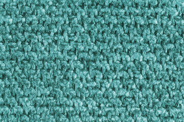 Texture of turquoise jacquard fabric, close up of rough weave macro. Material for home textile,...