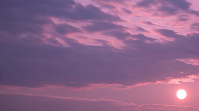 Vibrant sunrise with purple clouds in the sky, tranquil atmosphere. Nature and serenity concept