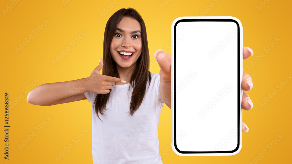 Poster mobile advertisement. excited lady pointing on smartphone with blank screen, emotional surprised wom