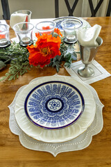 Formal table set with fine porcelain blue and white plate with a coral pattern on embroidered doily