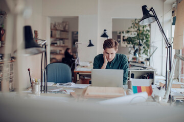 Young male architect working on a project in the office