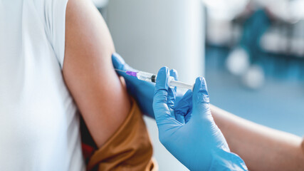 Time To Vaccinate Concept. Closeup Cropped View Of Unrecognizable Young Lady Getting Vaccine Injection In Arm Sitting With Doctor Or Nurse In Hospital. Immunization, Cure Medicine And Treatment